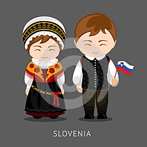 Slovenes in national dress with a flag.