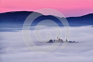 Slovenia beautiful landscape with mist and church in the morning