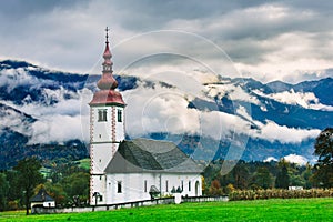 Slovenia landscape near.Bohinj lake. Iconic Slovenian Temple with Beautiful foggy mountains in the background.