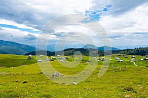 Slovenia mountains near the Kamnik city on Velika Planina pasture land. View of mountains with white clouds and blue sky, mist in