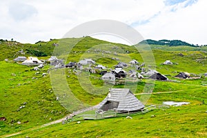 Slovenia velika planina big plateau, agriculture pasture land near city Kamnik in Slovenian Alps. Wooden houses on green land