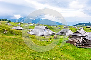 Slovenia velika planina big plateau, agriculture pasture land near city Kamnik in Slovenian Alps. Wooden houses on green land