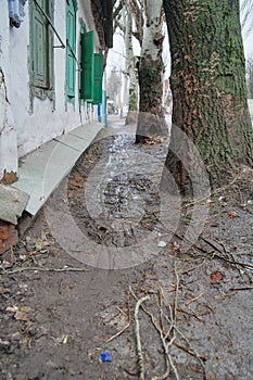 Sloviansk, Ukraine - February 12 2021: Sidewalk in mud at Svetlodarska street