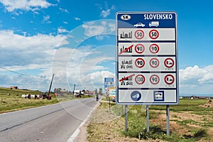 Slovkia border, 07.01.2016 - Traffic sign on the country border and tractor work on the agricultural land