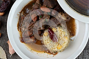 Slow cooked lamb with potato and dates served with warm couscous and chickpeas