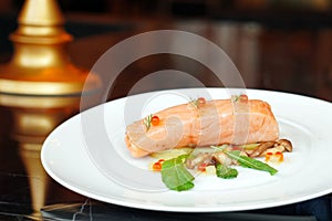 Slow Cooked Salmon fillet steak with salad and roe salmon on white plate