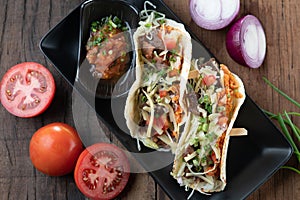 Slow cooked short ribs on tortillas with a spring onion tomato salsa