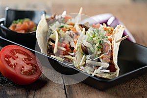 Slow cooked short ribs on tortillas with a spring onion tomato salsa