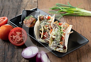 Slow cooked short ribs on tortillas with a spring onion tomato salsa