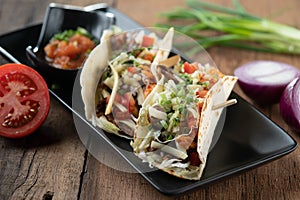 Slow cooked short ribs on tortillas with a spring onion tomato salsa