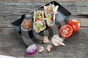 Slow cooked short ribs on tortillas with a spring onion tomato salsa