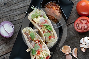 Slow cooked short ribs on tortillas with a spring onion tomato salsa