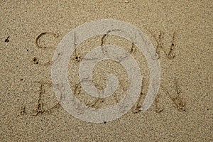 Slow down, mindfulness concept written on sand