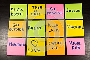 Slow down, relax, take it easy, keep calm, love, enjoy life, have fun and other motivational lifestyle reminders on colorful stick