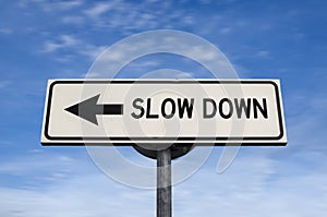 Slow down road sign, arrow on blue sky background