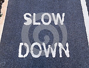 'SLOW DOWN' sign marking on bike lane