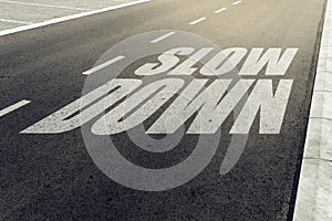 Slow down speed limit sign on highway