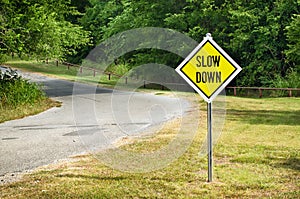 Slow Down yellow traffic sign