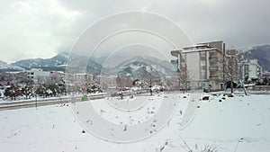 A slow, drone-like ascent captures a snowy day