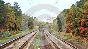 Slow flight over the railway line in the autumn forest.