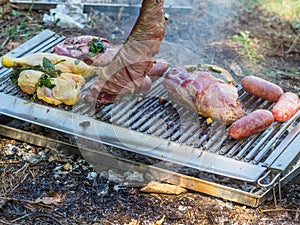 slow grilling chorizo sausages , chicken quarters, skirt and flank muscle steaks argentinian cuts photo