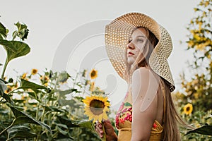 Slow Living concept New Lifestyle Trend. Relaxing young woman with lowers in nature, in corn, sunflower field