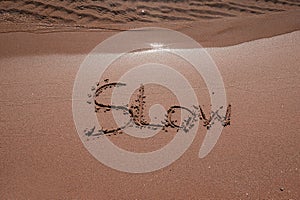 slow mindfulness concept written on sand