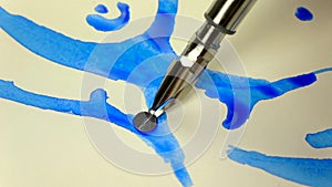 Slow-mo footage. Artist girl hand draws a pen with blue ink. close-up
