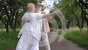 Slow motion. An active seniors having fun spending their leisure, enjoy life and smiling. A happy married couple spins