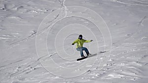 Slow motion active sport male snowboarder ride on track surrounded by snow aerial shot