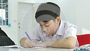 Slow motion of Asian children doing homework on white table