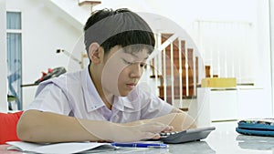 Slow motion of Asian children doing homework on white table