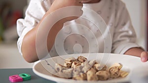 Slow motion Asian Chinese Toddler feeding herself with bread