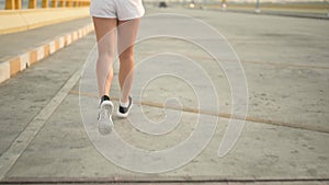 Slow motion athlete woman running at the beach road. Asian female runner endurance training in summer.