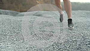 Slow motion athlete woman running at the rock. Asian female runner endurance training in summer.