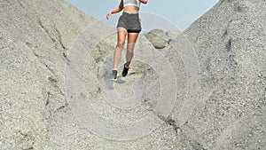 Slow motion athlete woman running at the rock. Asian female runner endurance training in summer. Healthy lifestyle and sport