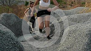 Slow motion athlete woman running at the rock. Asian female runner endurance training in summer. Healthy lifestyle and sport