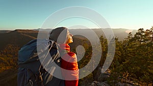 slow motion b-roll of Happy joyful woman on top of mountain enjoying beautiful view, standing with open arms, hike in