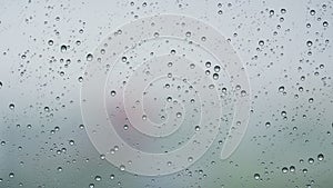Slow motion background of raindrop sliding on window glass