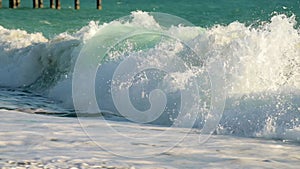 Slow motion barreling wave with texture and wind spray