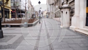 Slow motion blurred video on city street. Urban alley. Empty crosswalk. distance