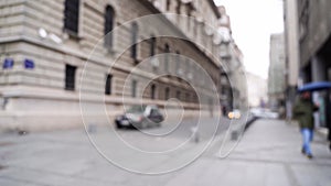 Slow motion blurred video on city street. Urban alley. Empty crosswalk. distance