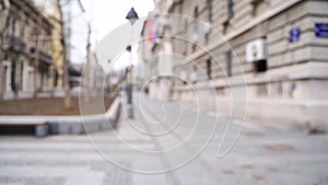 Slow motion blurred video on city street. Urban alley. Empty crosswalk. distance