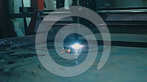 Slow motion of bright sparks flying out during plasma cutting of metal.