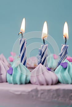 slow motion of burning candle on a birthday cake on light purple background