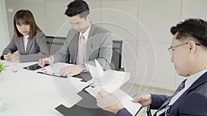 Slow motion - Businessman meeting in workplace with his colleague and signing a contract.