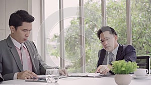 Slow motion - Businessman meeting in workplace with his colleague and signing a contract.