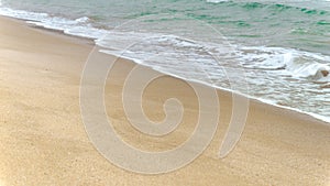 Slow motion of calm sea waves rolling on sandy beach on cold cloudy day. End of seasonal tourism, travel in winter