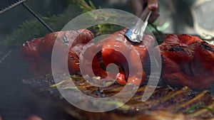 Slow motion chef cooking delicious red pepper and a ribs pork on barbecue.