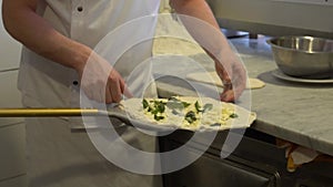 Slow motion chef prepares fresh original Italian raw pizza with ingredients